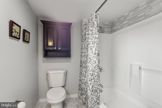 full bathroom with marble finish floor, shower / bath combo, toilet, and baseboards