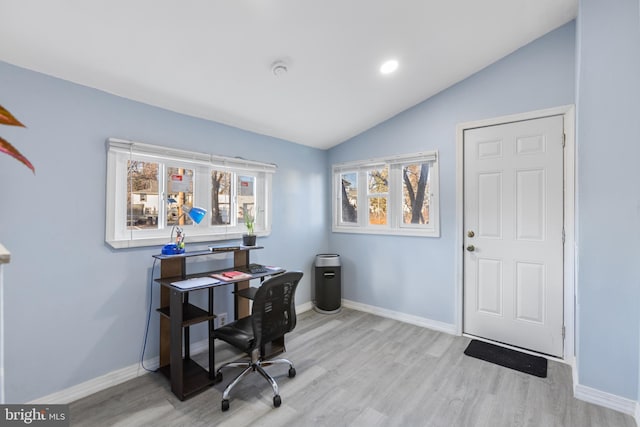 office area with vaulted ceiling, wood finished floors, and baseboards