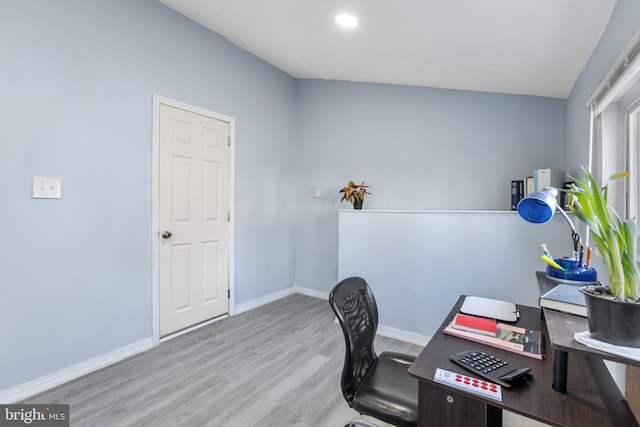 office space with baseboards and wood finished floors