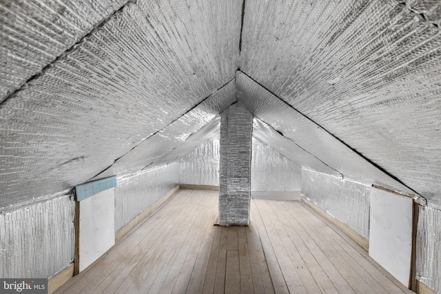 additional living space with lofted ceiling and hardwood / wood-style floors