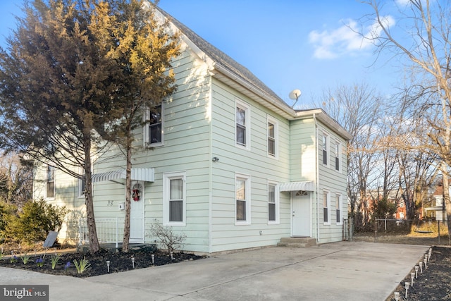 exterior space featuring entry steps and fence