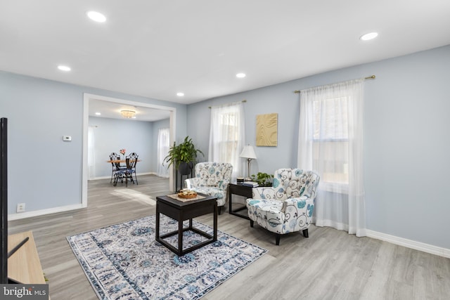 living area featuring recessed lighting, wood finished floors, and baseboards