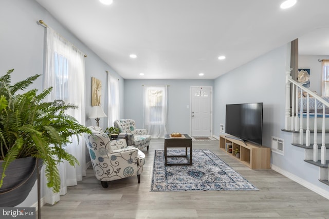 living room with recessed lighting, stairway, baseboards, and wood finished floors