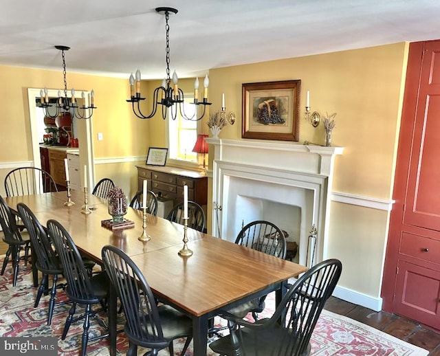 dining area featuring dark wood-type flooring and an inviting chandelier