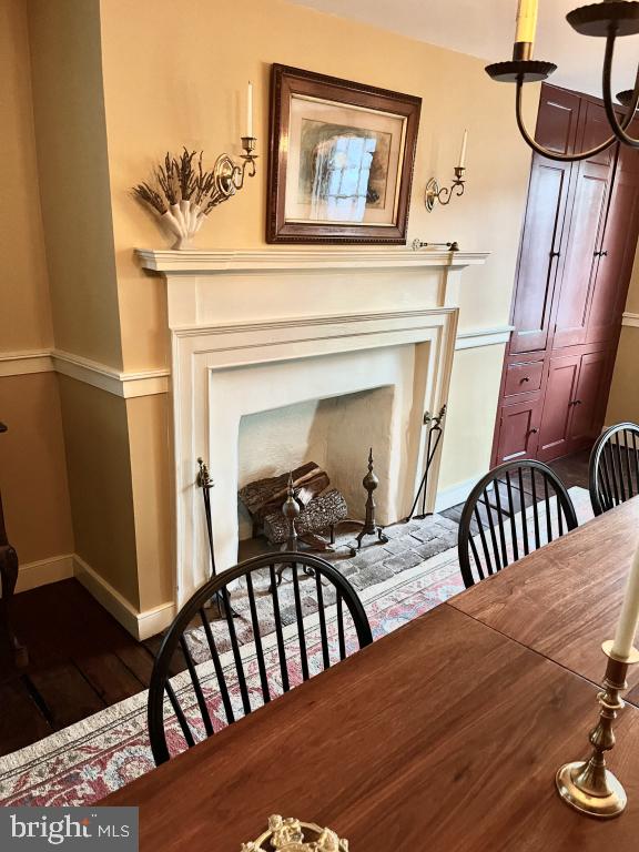 dining area with dark hardwood / wood-style flooring