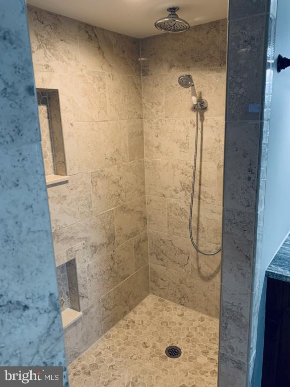 bathroom with tiled shower