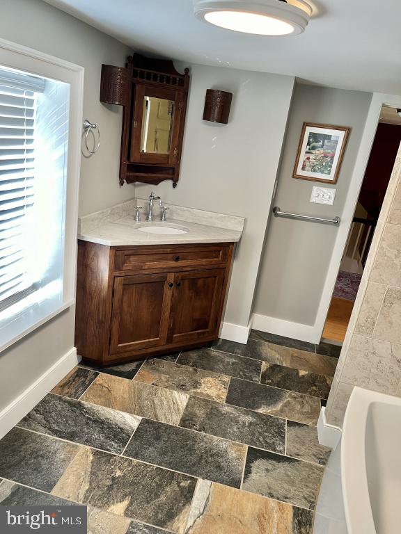 bathroom featuring a tub and vanity