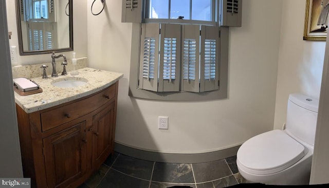 bathroom featuring tile patterned floors, vanity, and toilet