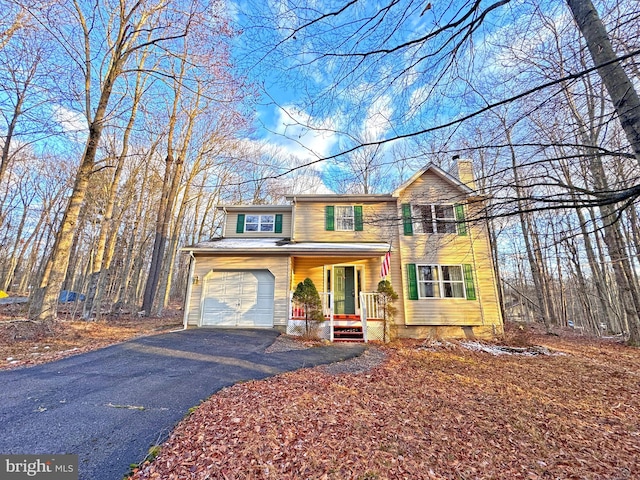 view of front property with covered porch and a garage