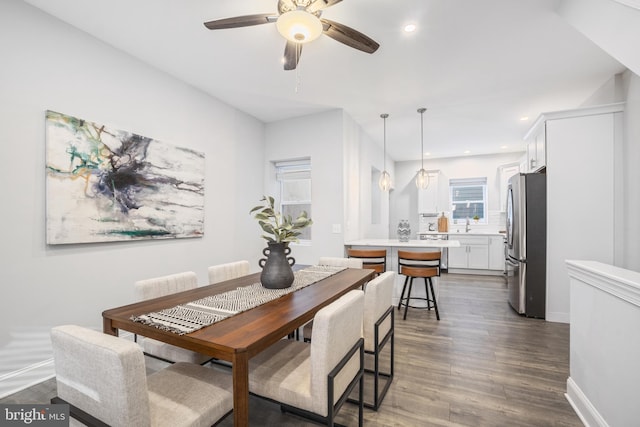 dining room with dark wood-type flooring and ceiling fan