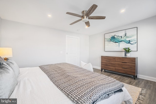 bedroom with dark hardwood / wood-style floors and ceiling fan