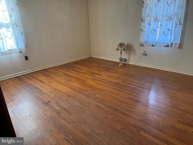 unfurnished room featuring dark hardwood / wood-style flooring