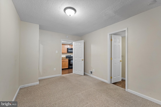 unfurnished bedroom featuring carpet floors and a textured ceiling