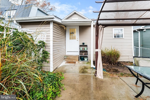 property entrance featuring a patio