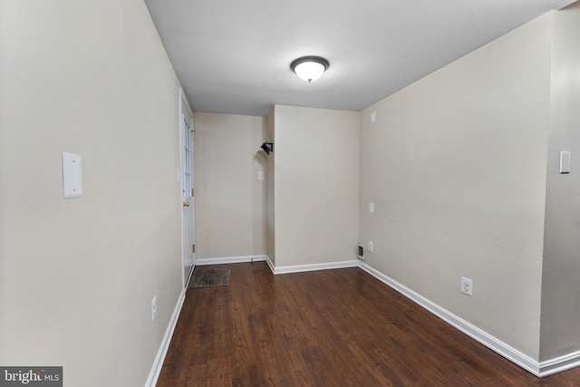 clothes washing area featuring dark hardwood / wood-style floors