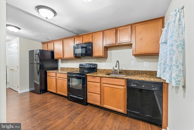 kitchen featuring stone counters, sink, dark hardwood / wood-style flooring, a textured ceiling, and black appliances