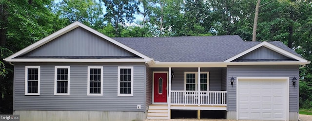 view of front of property featuring covered porch and a garage