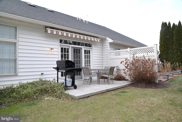 exterior space with a lawn, a patio area, and grilling area