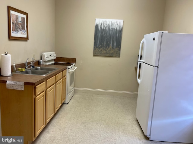 kitchen featuring white appliances and sink