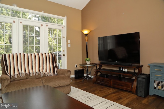 living room with dark hardwood / wood-style flooring and lofted ceiling