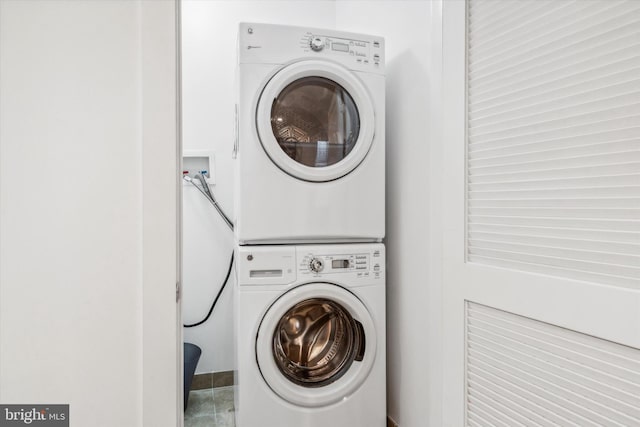 washroom with stacked washer / drying machine