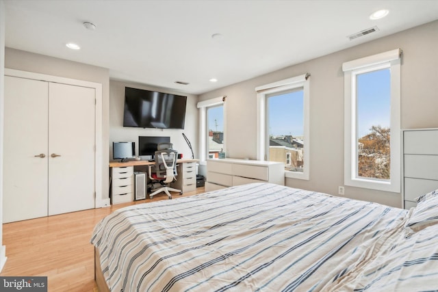 bedroom featuring light hardwood / wood-style flooring and a closet