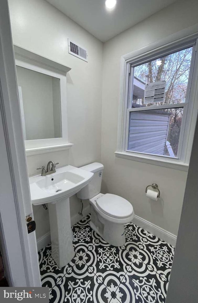 bathroom featuring tile patterned floors, toilet, and sink