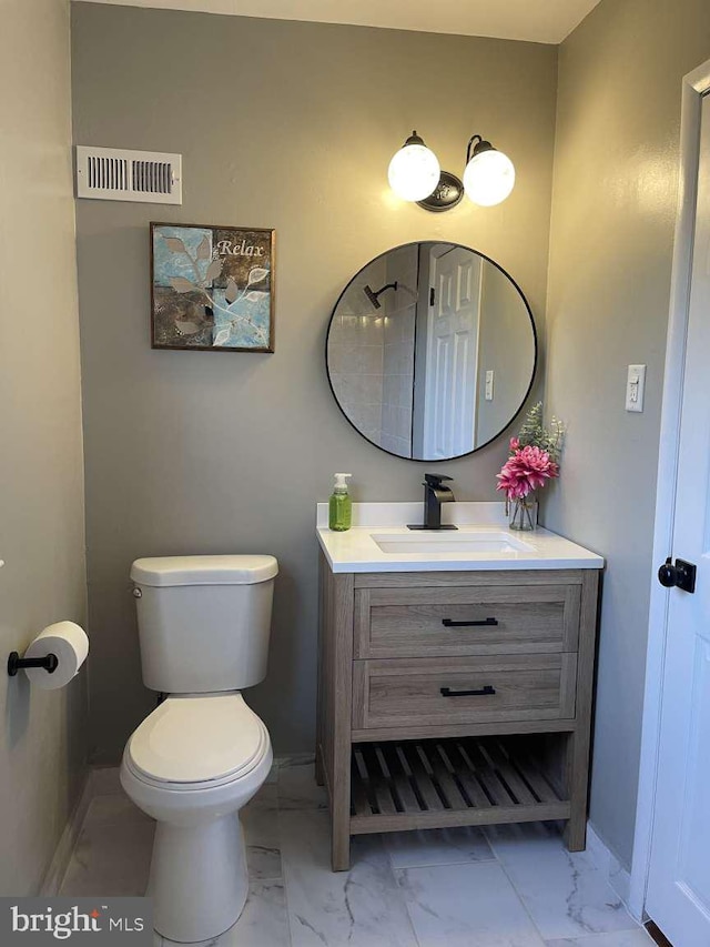 bathroom with vanity and toilet