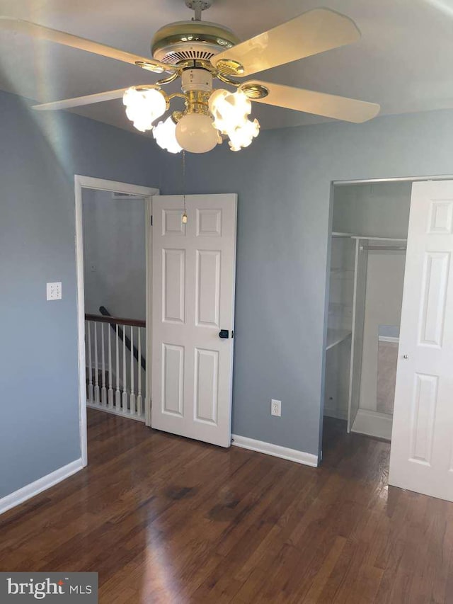 unfurnished bedroom featuring ceiling fan and dark hardwood / wood-style floors