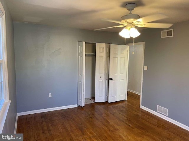 unfurnished bedroom with dark hardwood / wood-style floors and ceiling fan