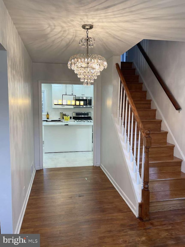 interior space featuring hardwood / wood-style flooring and a chandelier