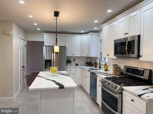 kitchen with a kitchen island, sink, white cabinetry, and stainless steel appliances