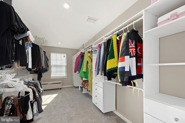 spacious closet featuring baseboard heating and light colored carpet