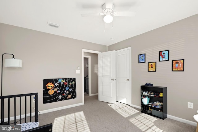 interior space with a nursery area and ceiling fan