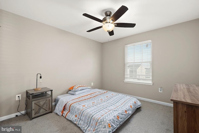 bedroom featuring ceiling fan and light carpet