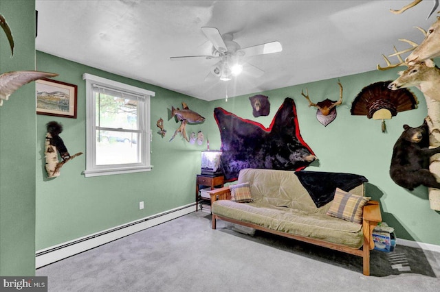 living area featuring ceiling fan, carpet floors, and a baseboard heating unit