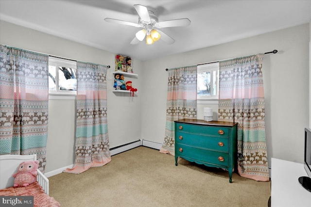 bedroom with light colored carpet, baseboard heating, and ceiling fan