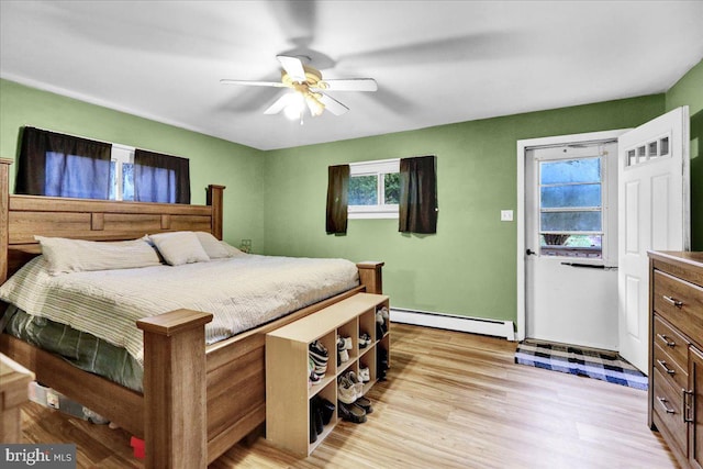 bedroom featuring a baseboard radiator, ceiling fan, and light hardwood / wood-style floors