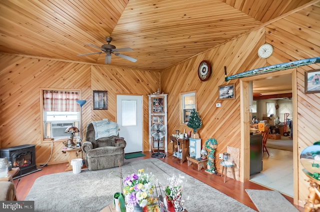 living room featuring a wood stove, wood walls, cooling unit, and wood ceiling