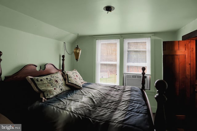 bedroom with cooling unit and lofted ceiling