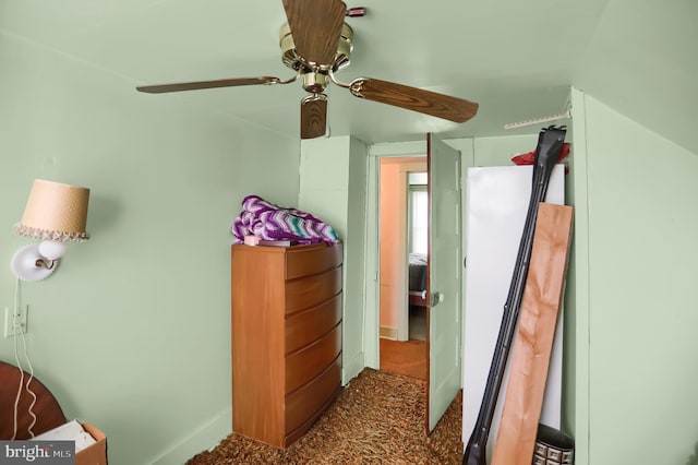 bedroom with dark colored carpet and ceiling fan