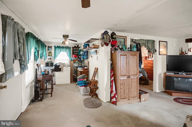 living room with ceiling fan and carpet