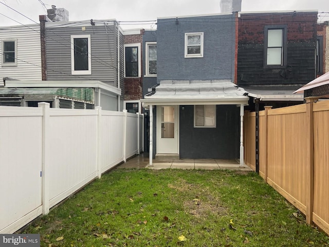 rear view of house with a lawn