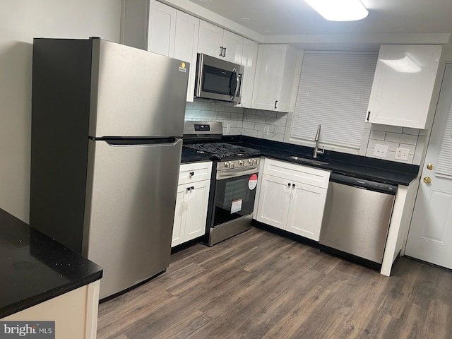 kitchen featuring white cabinets, stainless steel appliances, and dark hardwood / wood-style floors