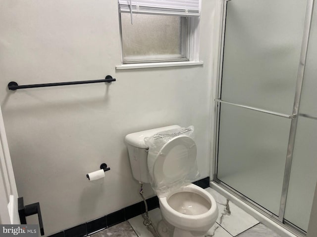 bathroom with toilet and walk in shower