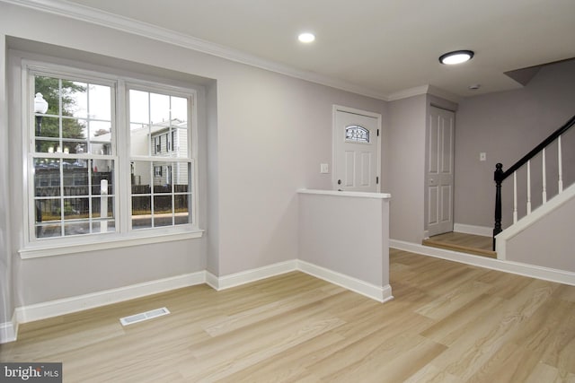 foyer featuring light hardwood / wood-style flooring and ornamental molding