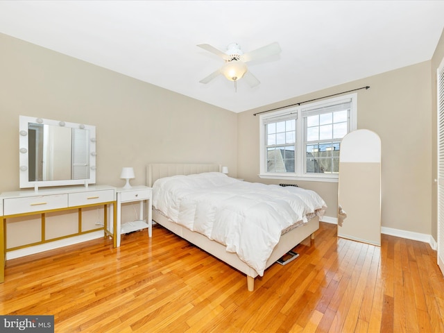 bedroom with light hardwood / wood-style floors and ceiling fan