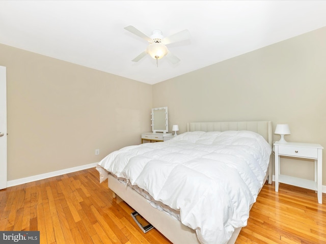 bedroom with ceiling fan and hardwood / wood-style flooring