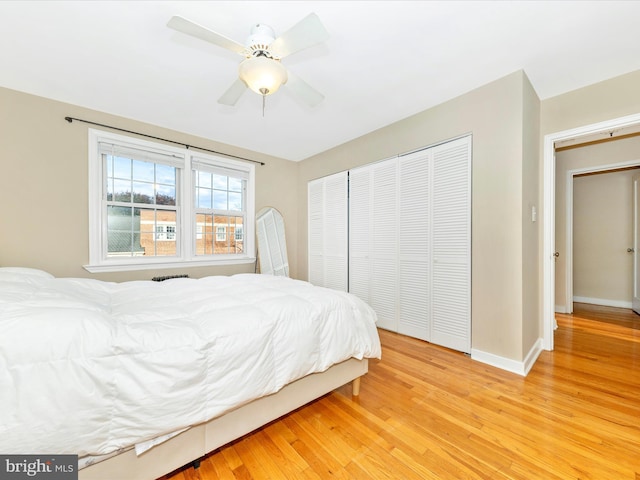 bedroom with a closet, light hardwood / wood-style flooring, and ceiling fan