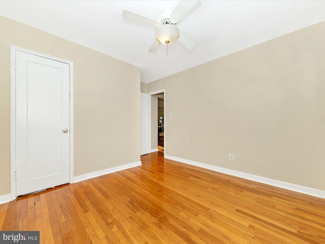 unfurnished room featuring ceiling fan and hardwood / wood-style flooring